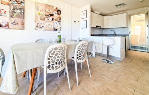 a kitchen and dining room with a table and chairs at 3 Bedroom Nice Home In Torrevieja in Torrevieja
