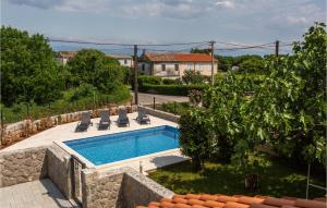 a swimming pool in a yard with chairs and a house at Amazing Home In Polje With Wifi in Polje +18 photos