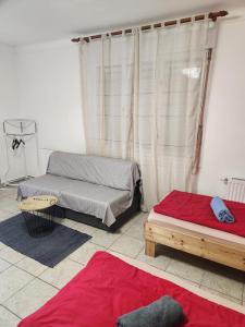 A bed or beds in a room at Orsi Apartman / vendegház