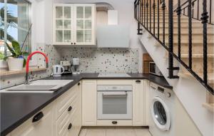 a kitchen with a sink and a washing machine at 3 Bedroom Nice Home In Kornic in Kornić