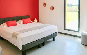 a bedroom with a large bed with red walls at Cozy Home In Maillane With Kitchen in Maillane