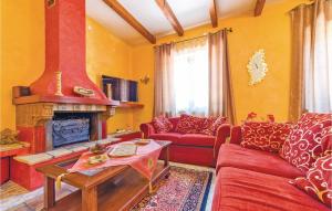a living room with a red couch and a fireplace at Villa Gaia in Menfi