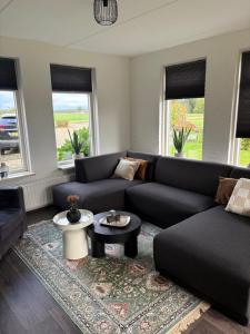 a living room with a couch and a table at Bij de Buurman in Dalmsholte