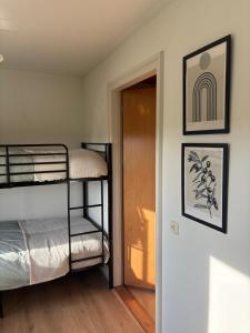 a room with two bunk beds and a door at Bij de Buurman in Dalmsholte +6 photos