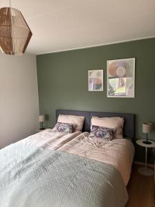 a bedroom with a large bed with two pillows at Bij de Buurman in Dalmsholte