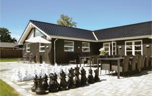 a chess board on a patio in front of a house at Stunning Home In Gilleleje With Sauna in Gilleleje +30 photos