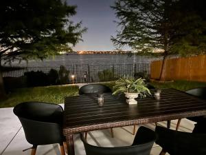 a wooden table and chairs with a view of the water at Lake Front Home, around 15 minutes drive to AT&T and Epic Water in Grand Prairie