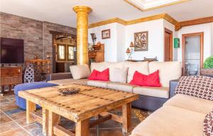 a living room with a couch and a table at 7 Bedroom Stunning Home In Frigiliana in Acebuchal +42 photos