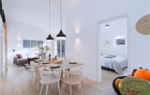 a dining room and living room with a table and chairs at Beach Front Home In Lembruchdümmer See in Lembruch