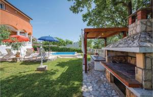 a backyard with a bench and an outdoor grill at Three-Bedroom Holiday Home In Nedescina in Nedeščina +26 photos