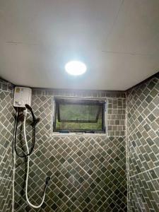 a bathroom with a shower with a window at Khao Sok Green Mountain View in Khao Sok National Park