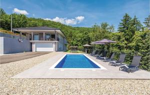 a backyard with a swimming pool and chairs and a house at Gorgeous Home In Bregi With Kitchen in Breza +56 photos