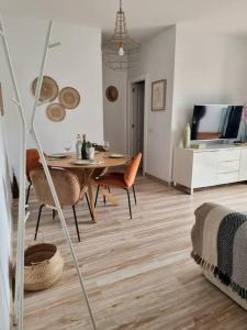 a living room with a table and chairs and a television at Casa Berry in Costa Teguise +20 photos
