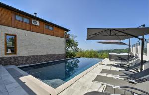 a swimming pool with chairs and an umbrella at Stunning Home In Donja Poljana in Donja Poljana +46 photos