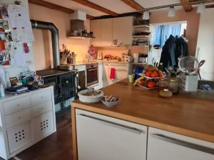 a kitchen with a wooden counter top in a room at Maison de charme entre ville et campagne in La Neuveville +20 photos
