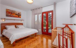 a bedroom with a bed and a wooden floor at 4 Bedroom Pet Friendly Home In Malinska in Malinska +24 photos