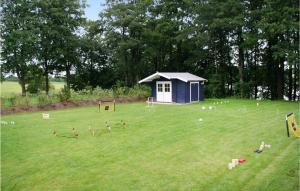 a playground with a small blue building in a field at Awesome Home In Krems Iiwarderbrück in Göls +13 photos