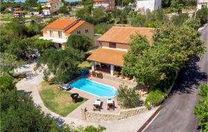 an aerial view of a house with a swimming pool at 3 Bedroom Cozy Home In Palit in Palit