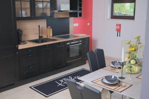 a kitchen with a table with a sink and a counter top at Eifeltraum Marianus in Nieder-Emmels