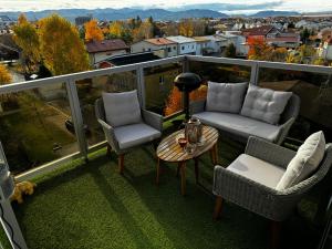 a balcony with a couch and chairs and a table at Rubicon in Poprad