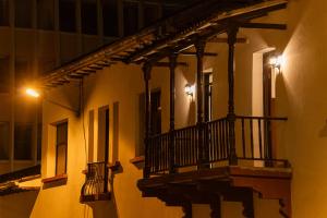 a balcony on a building at night at Hotel Boulevard del Río in Cali