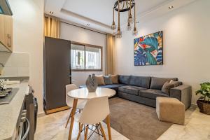 a living room with a couch and a table at AeroStudio in Nouaceur