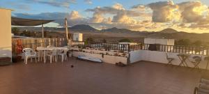 a balcony with tables and chairs and a view of mountains at Sunset house in Soo
