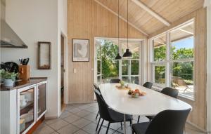 a kitchen and dining room with a white table and chairs at Holiday Home Klitvej Ebeltoft X in Ebeltoft