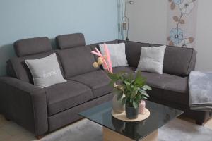 a living room with a couch and a table at Eifeltraum Marianus in Nieder-Emmels