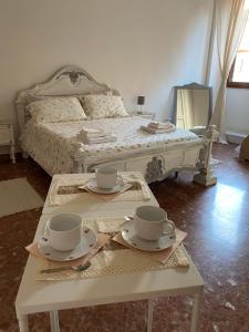 a bedroom with a bed with two coffee tables with cups at Romea in Campagnano di Roma