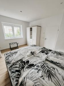 a bedroom with a bed with a black and white comforter at Ferienwohnungen Kornkammer und Kirschstübchen in Kettig