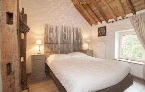 a bedroom with a large bed and a window at Dell'arte in Morville