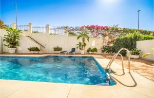 a swimming pool in front of a house at 2 Bedroom Lovely Apartment In Marbella in Marbella