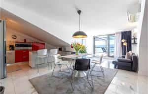 a kitchen and living room with a table and chairs at Apartment Krilo Jesenice 24 in Jesenice