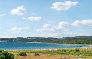 a view of a beach and the ocean at Holiday Home Klitvej Ebeltoft X in Ebeltoft +19 photos