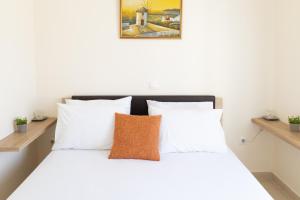 En eller flere senge i et værelse på Villa Divina Private Traditional House