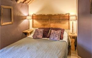 a bedroom with a large bed with purple pillows at Dell'arte in Morville