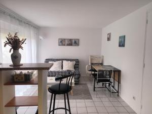 a living room with a couch and a table at Gîte de la Mardelle in Viarmes +8 photos