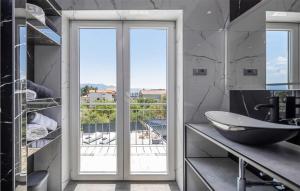 a bathroom with a sink and a glass door at Nice Home In Sucuraj With Wifi in Sućuraj
