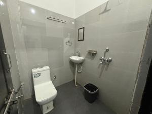 a bathroom with a toilet and a sink at The White house in Varanasi
