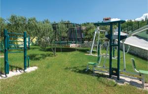 a park with a playground with a slide at Nice Home In Sestanovac With Kitchen in Šestanovac