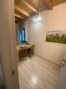 a dining room with a table and a painting on the wall at Agriturismo La Falesia in Bagnasco