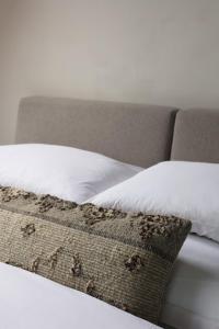 a close up of a bed with a white pillow at Górski Domek Zakopane in Kościelisko