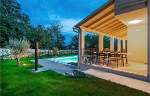 a patio with a table and chairs next to a pool at 5 Bedroom Nice Home In Manjadvorci in Manjadvorci +53 photos