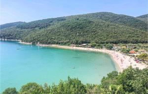 a beach with a bunch of people in the water at Apartment Rudarska V in Rabac +14 photos
