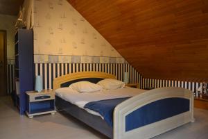 a bedroom with a bed with a wooden head board at La Maison du Bonheur in Gouvy +65 photos