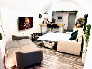 a living room with a couch and a table at Écrin de la rivière in Sourribes