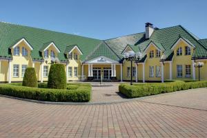 a large yellow house with a green roof at Imperial Casino Strazny Hotel in Strážný