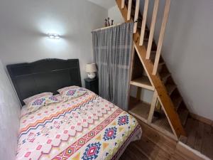 a bedroom with a bed next to a staircase at Louis Maissa in Saint-Martin-Vésubie