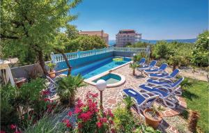 a group of chairs sitting next to a swimming pool at 6 Bedroom Beautiful Home In Crikvenica in Crikvenica